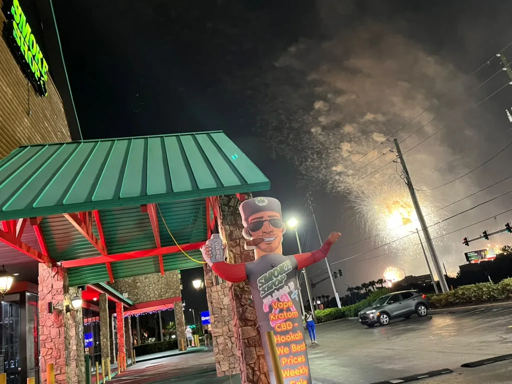 247 Smoke Shop storefront at night on W Sand Lake Road in Orlando