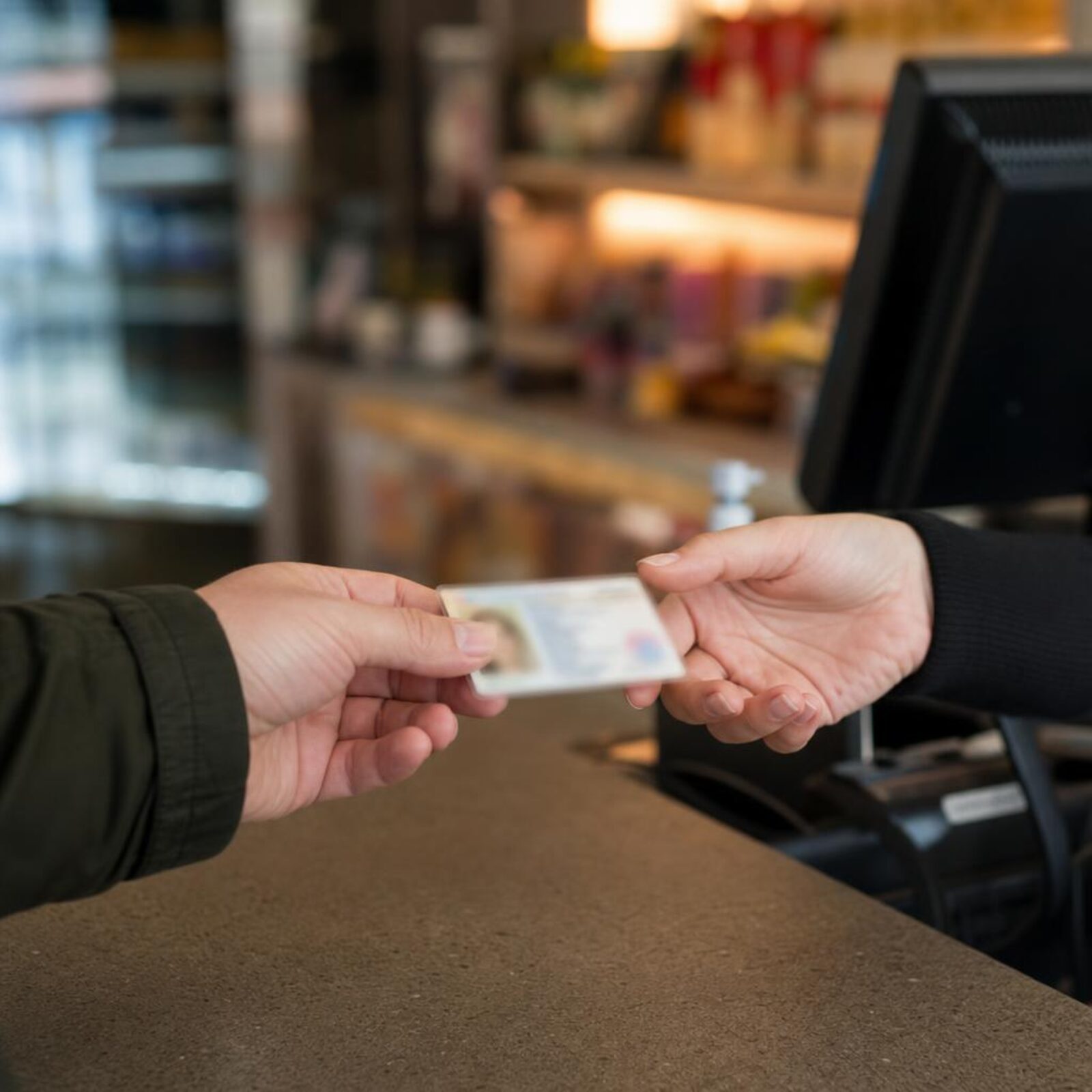 Government-issued identification card being checked for an adult purchase in Florida.