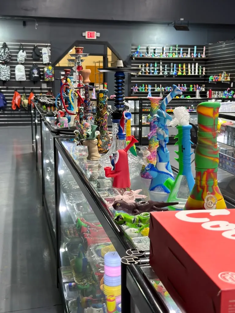Hookahs and colorful glass accessories displayed on counters inside 247 Smoke Shop.
