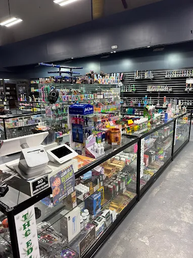 Inside 247 Smoke Shop — glass display cases stocked with vapes, THCA, and accessories