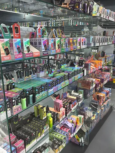 Wall of disposable vapes at 247 Smoke Shop Sand Lake / Universal Studio Orlando — pick any 3 for $69.99