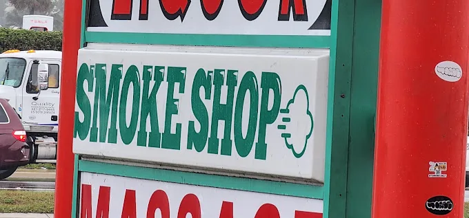 Smoke Shop road sign on W Sand Lake Rd in Orlando marking the plaza entrance