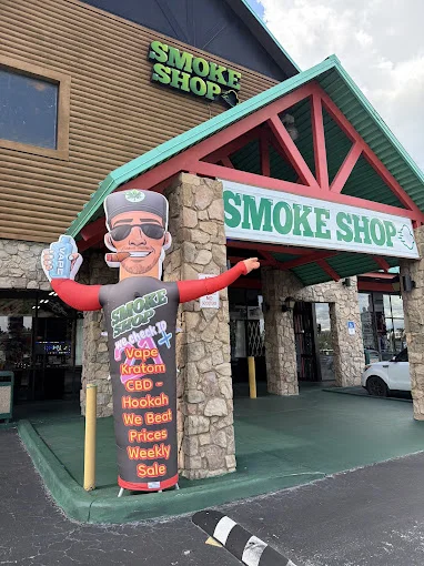 Storefront of 247 Smoke Shop on West Sand Lake Road in Orlando during the day