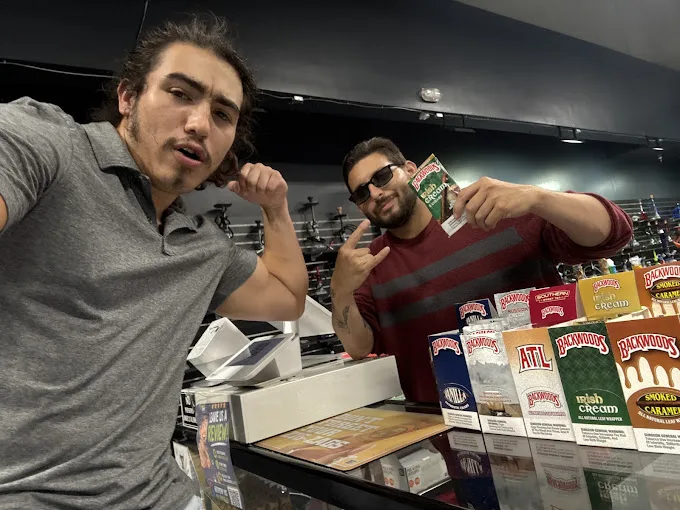 247 Smoke Shop team at the counter ready to assist customers with pickup orders.