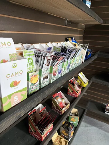 Shelves of blunt wraps and rolling papers including CAMO leaf wraps at 247 Smoke Shop